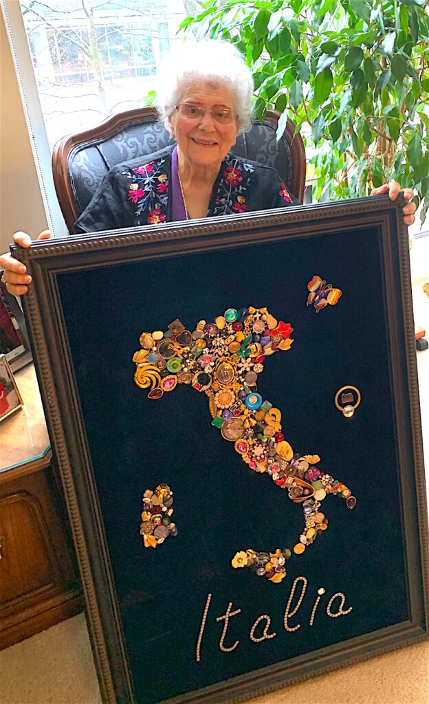 Lucy Salle, 2025 Festa Italiana Gill Centioli award winner, holding some of her artwork