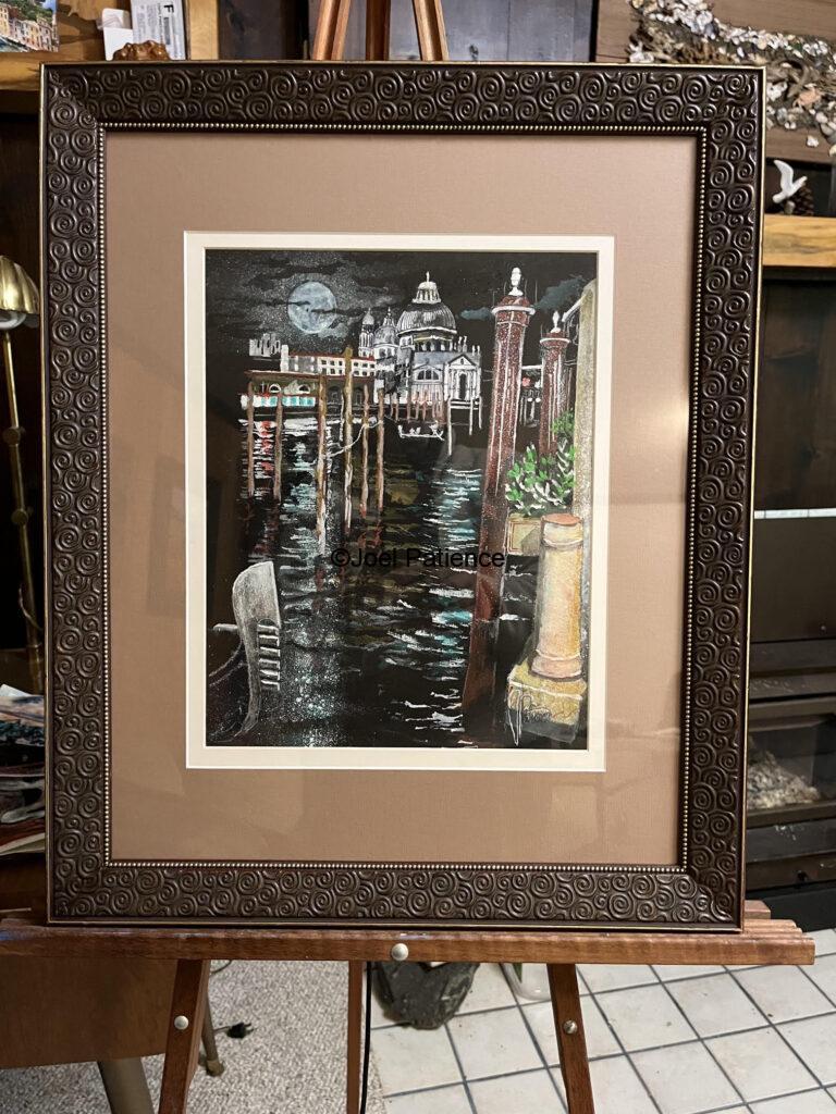 Photograph of a framed watercolor painting of La Serenissima Venice at night